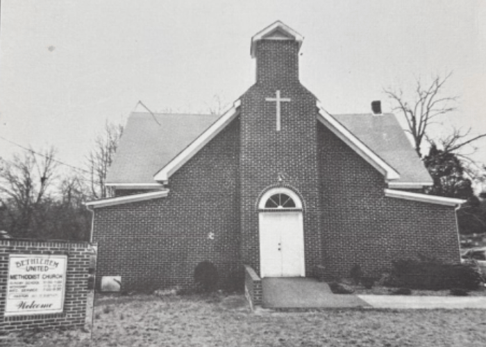 Historic black-and-white photo of Bethlehem United Methodist Church’s brick sanctuary, featuring the church sign and front cross structure in Greenville, SC.